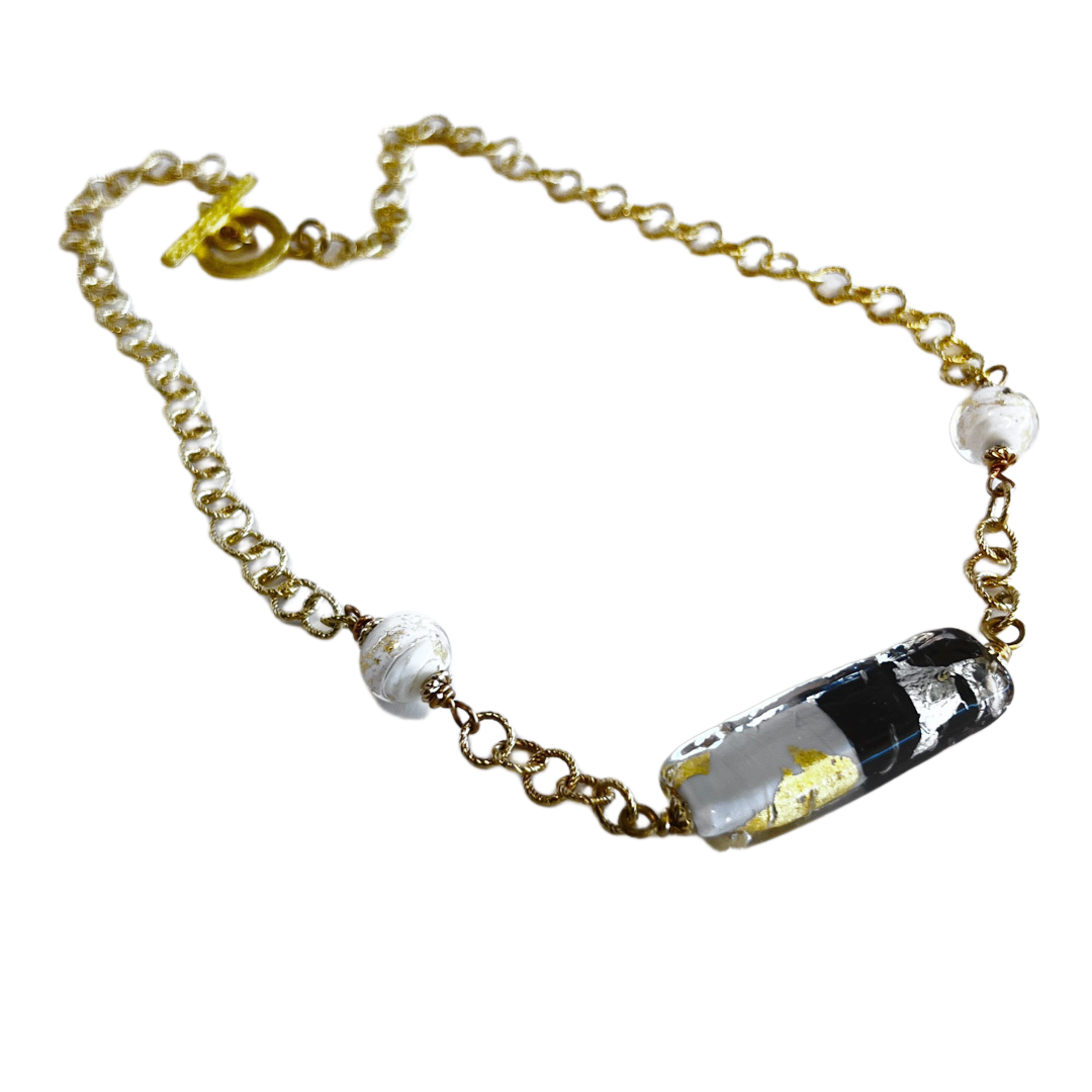 Italian blown glass encasing gold and silver foil, creating a simple yet elegant statement piece