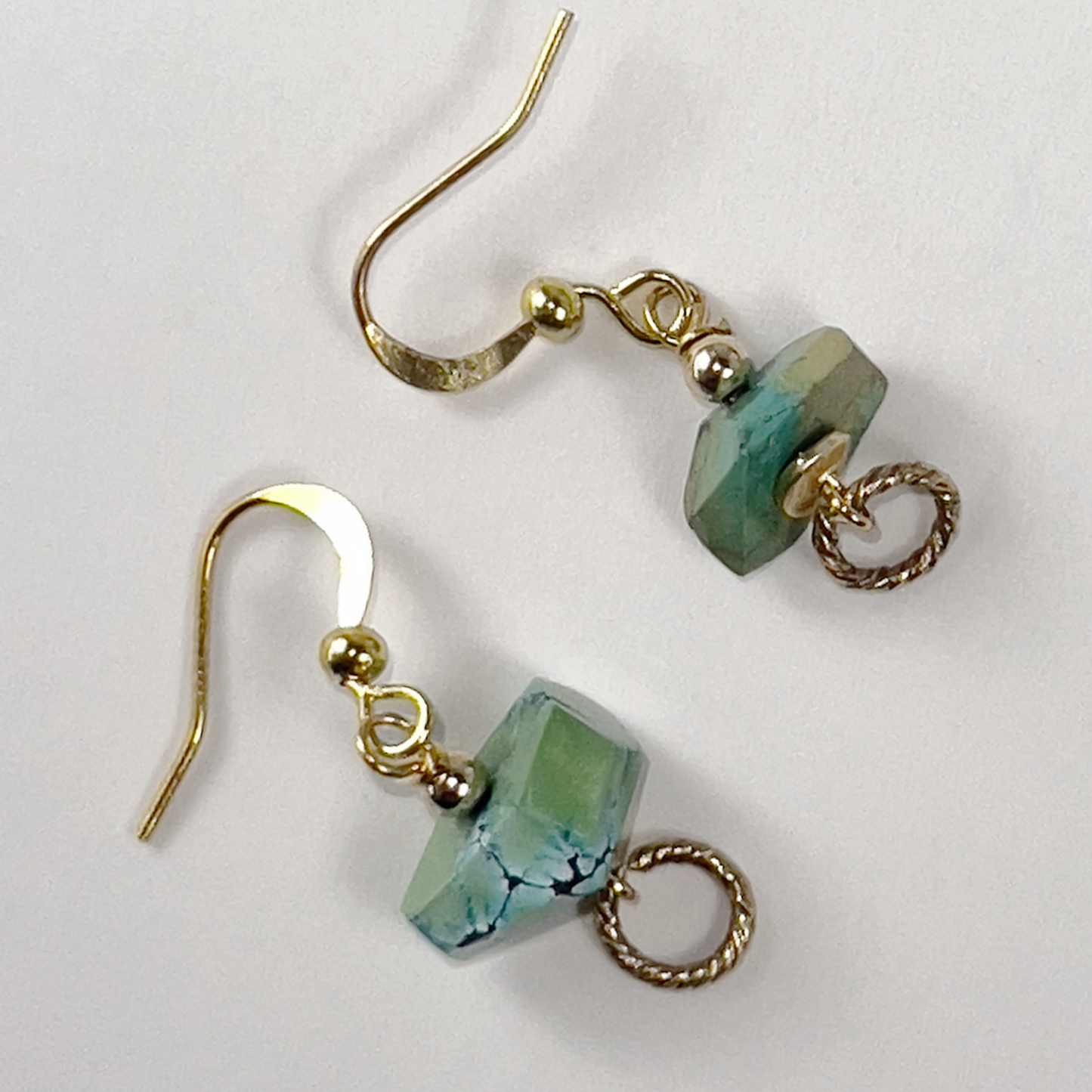 Sliced turquoise nugget earrings with sterling silver ear wires and gold cluster leaf accents.