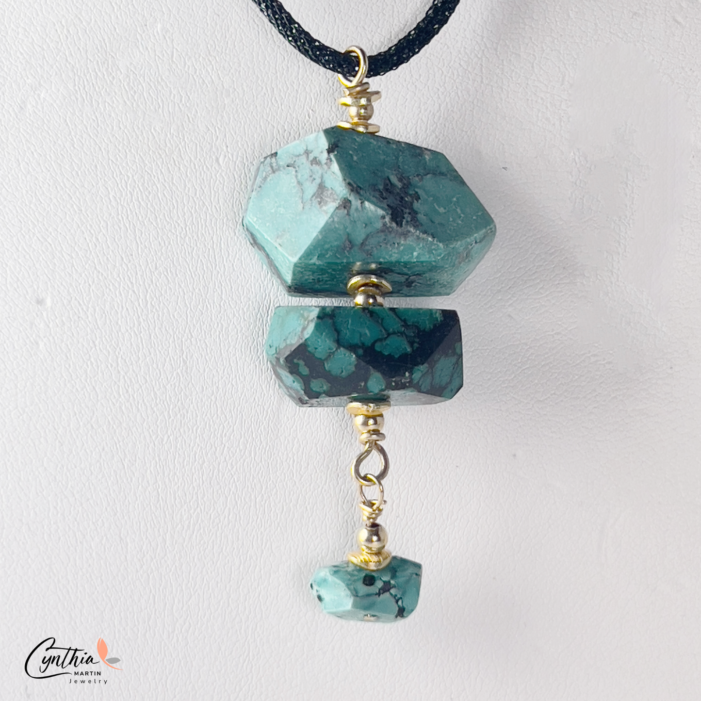 Authentic turquoise nugget pendant with gold chain drop, hanging from a black Italian crystal mesh necklace.