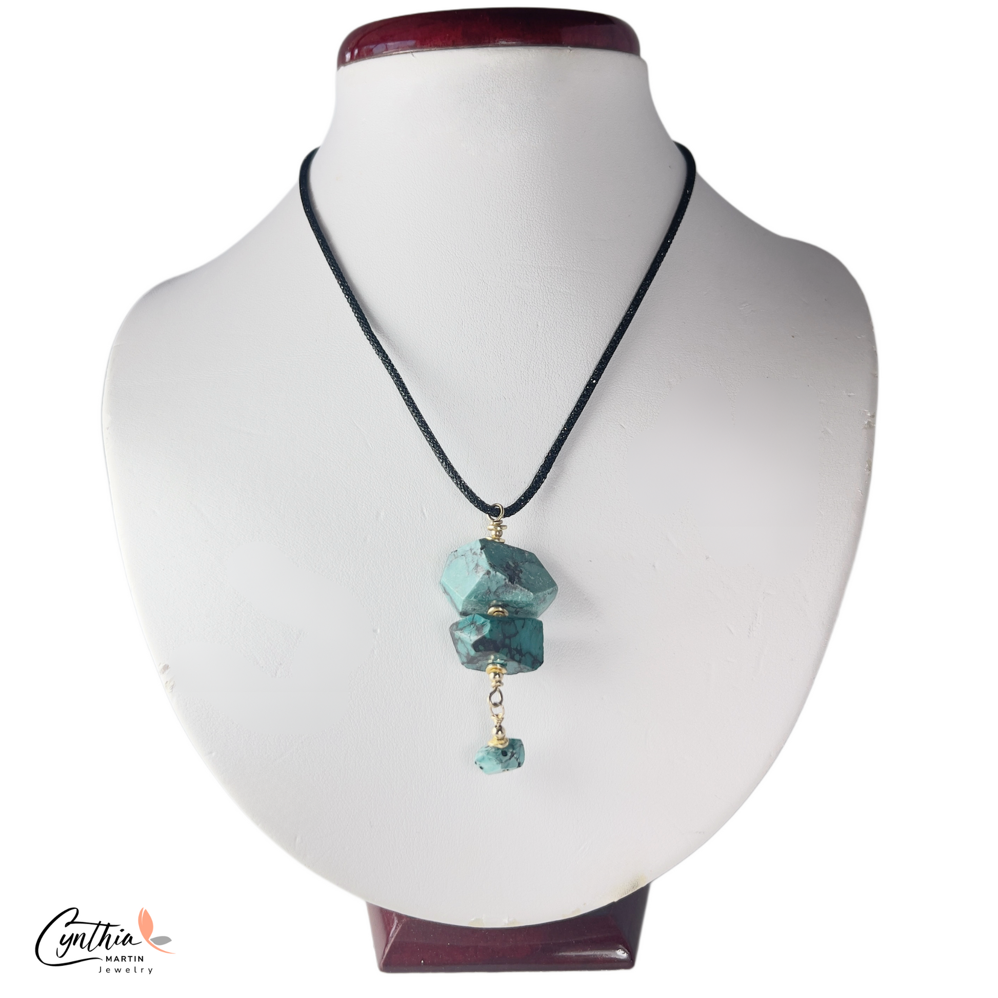 Authentic turquoise nugget pendant with gold chain drop, hanging from a black Italian crystal mesh necklace.