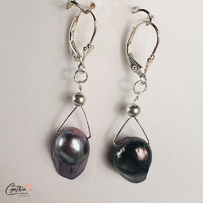 Earrings featuring exclusive dark plum freshwater pearls with elegant silver Bali bead spacers, 1 inch in height.
