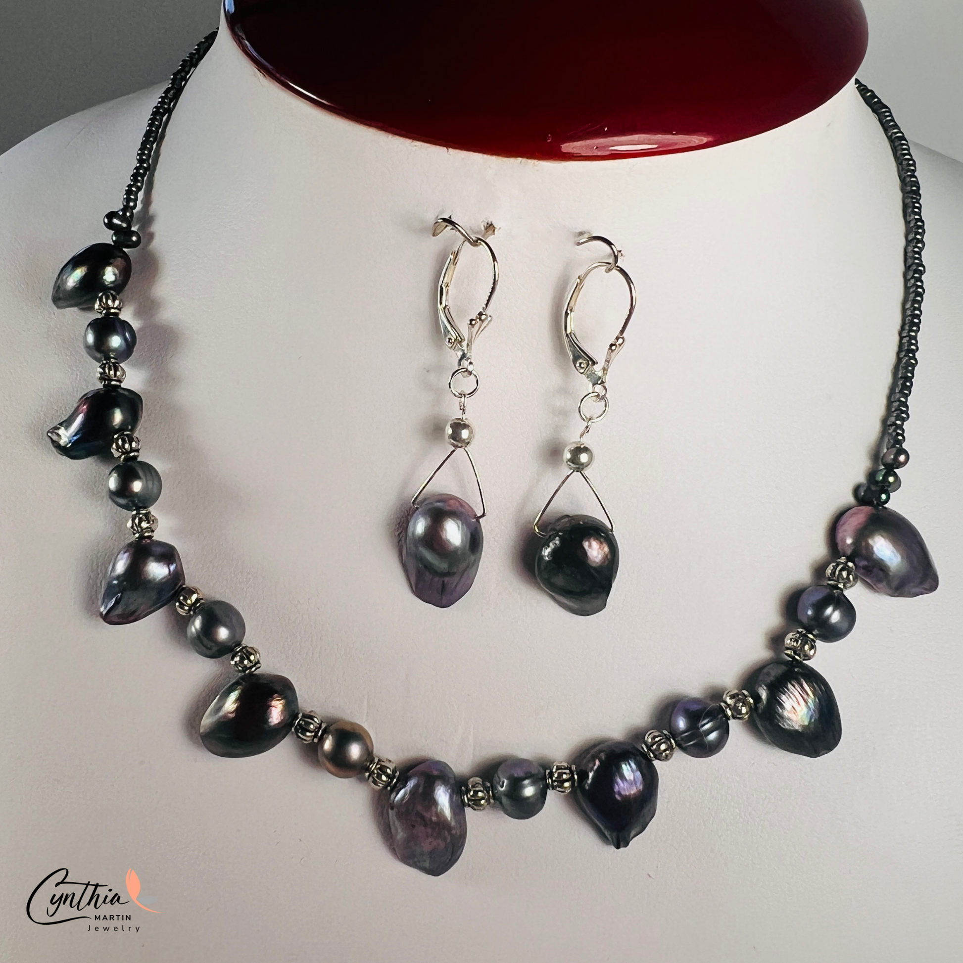 Necklace featuring exclusive dark plum freshwater pearls with silver Bali bead spacers, measuring 15 inches with a 2-inch extender.
