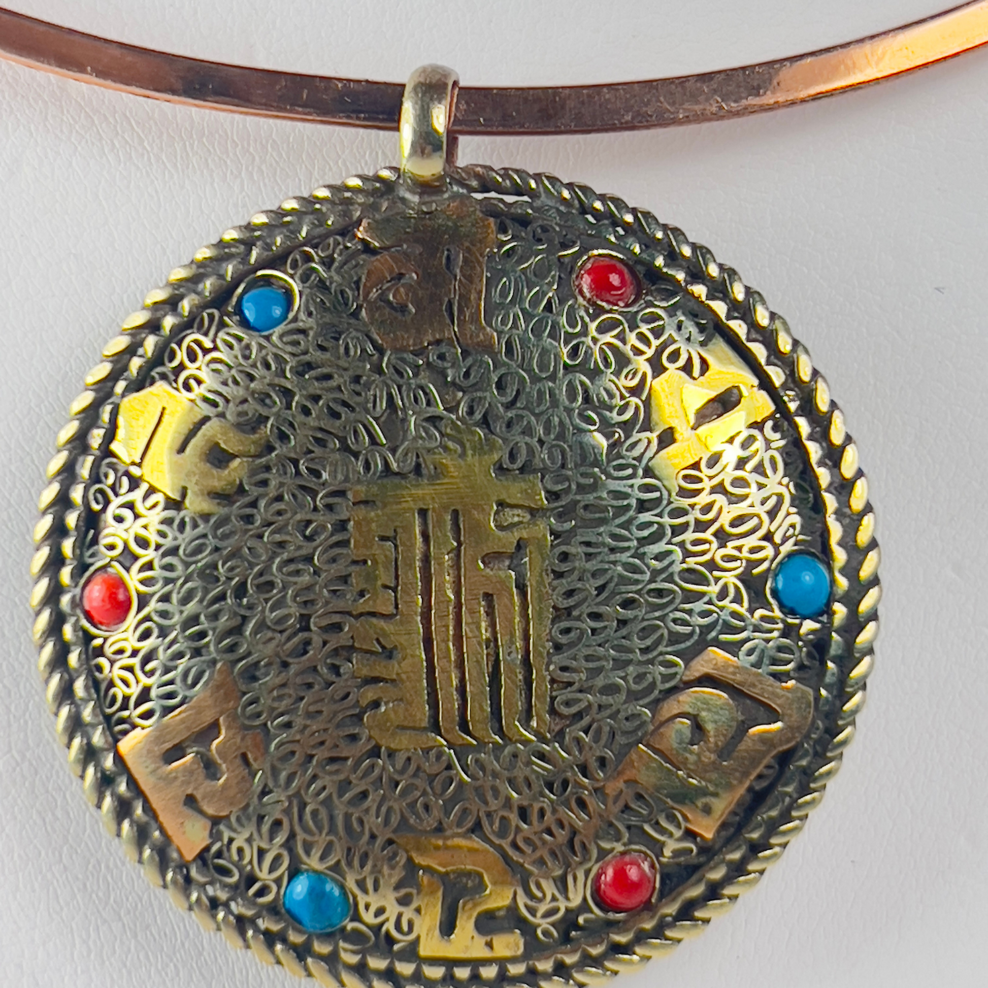 Ancient Chinese medallion pendant on a copper choker necklace.