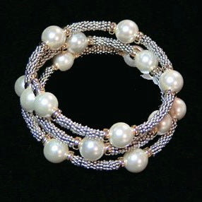 Stunning bracelet featuring strands of pearls wrapped around the wrist five times, interspersed with ornate Bali beads.