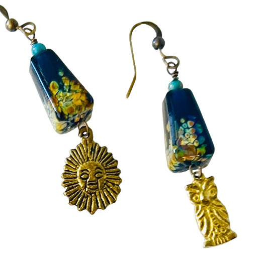 Earrings with Tucson porcelain beads, sun and owl charms, dangling on sterling silver ear wires.