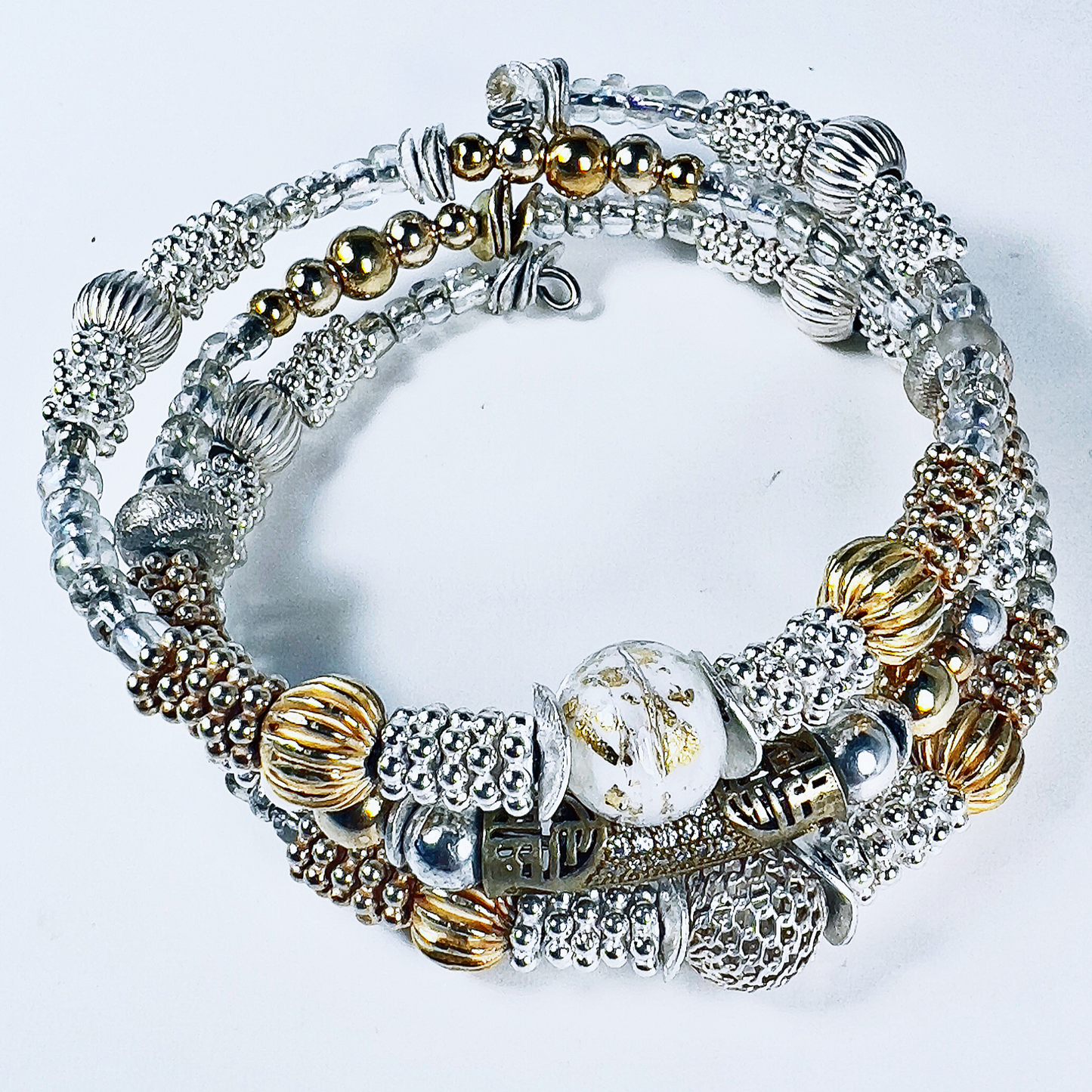 Collection of gold and silver-wrapped bracelets with bronze pave designed tube, silver and gold beads in multiple sizes, spacers, rondelles, and flat discs.