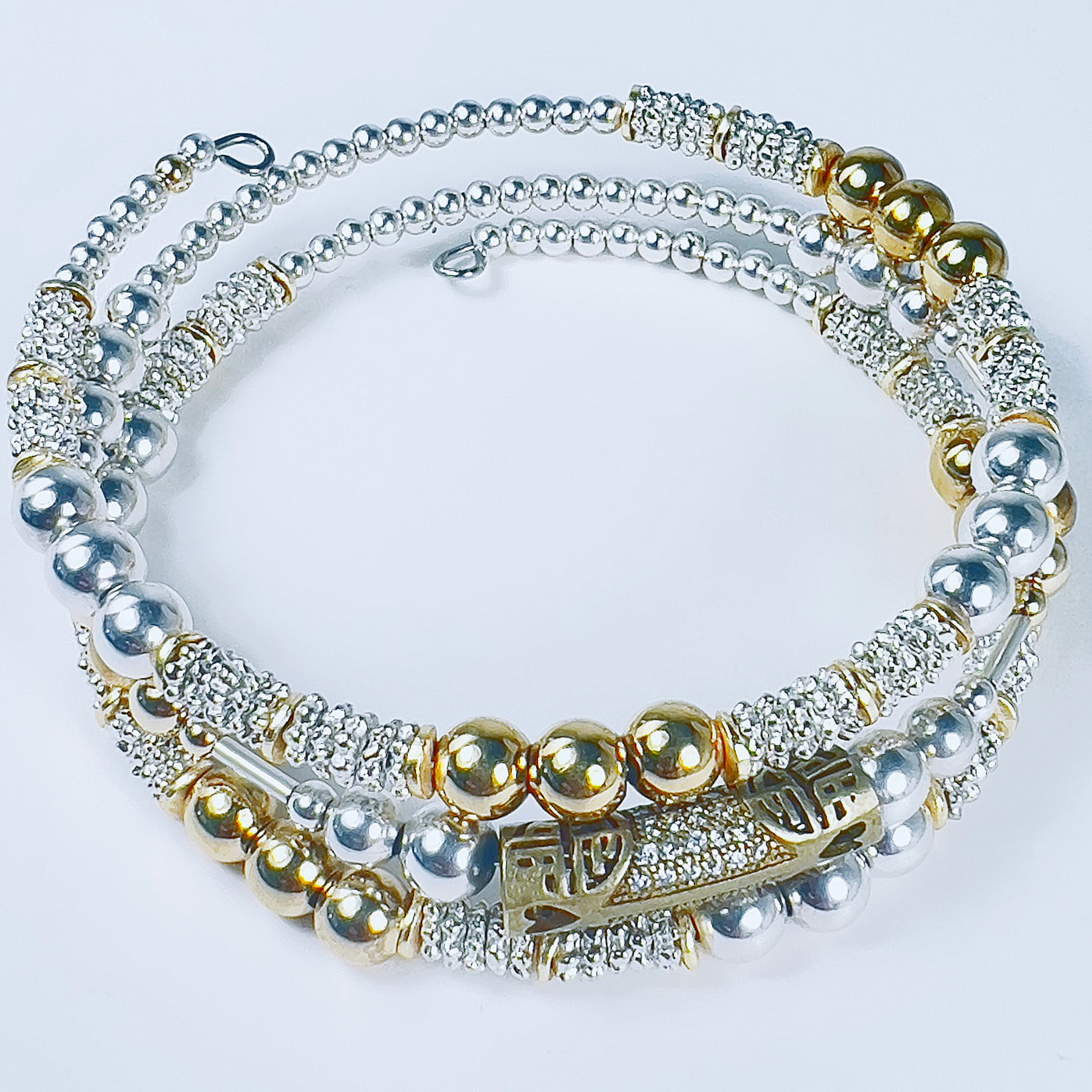 Three-wrap bracelet with Jakarta brass pave barrel, smaller gold and silver round beads, and tiny daisy spacers.