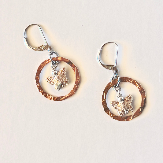 Multi-metal hammered round loop earrings with a sterling silver butterfly dancing in the center.