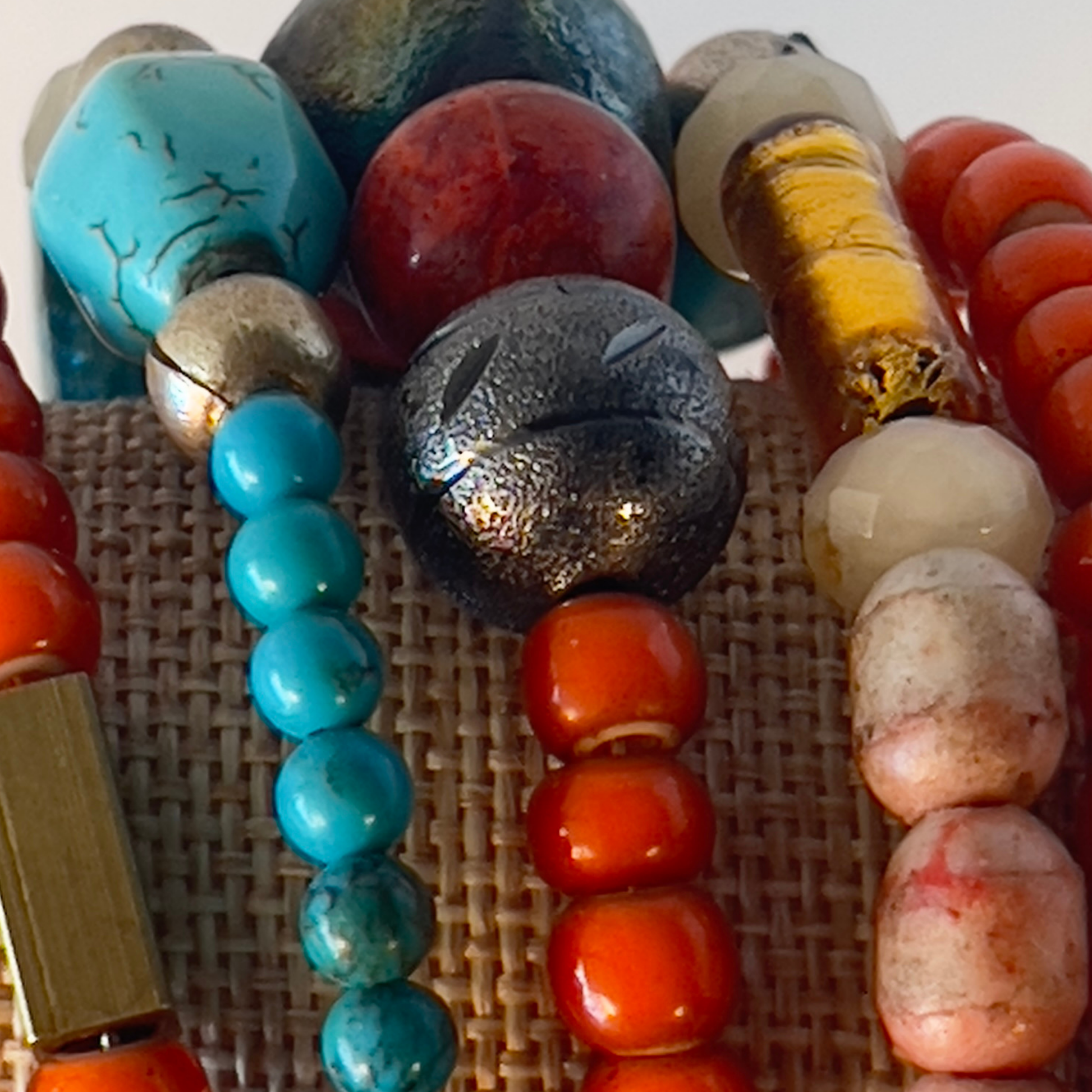 Celebrate the true Native American look with multi-orange coral and turquoise in various shapes, accented with brass and copper metals. Includes splashes of foiled Murano glass from Italy. Silver metal, one size fits all.