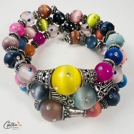Vibrant 4-layer bracelet featuring festive colors and crystal-covered beads, accented with Bali silver spacers and caps.