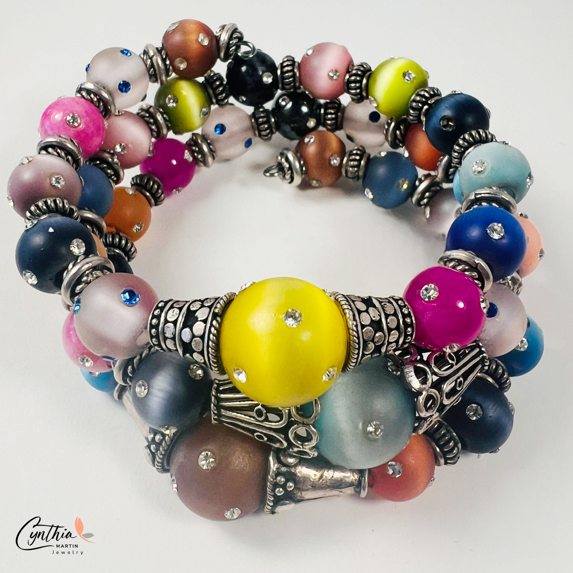 Vibrant 4-layer bracelet featuring festive colors and crystal-covered beads, accented with Bali silver spacers and caps.
