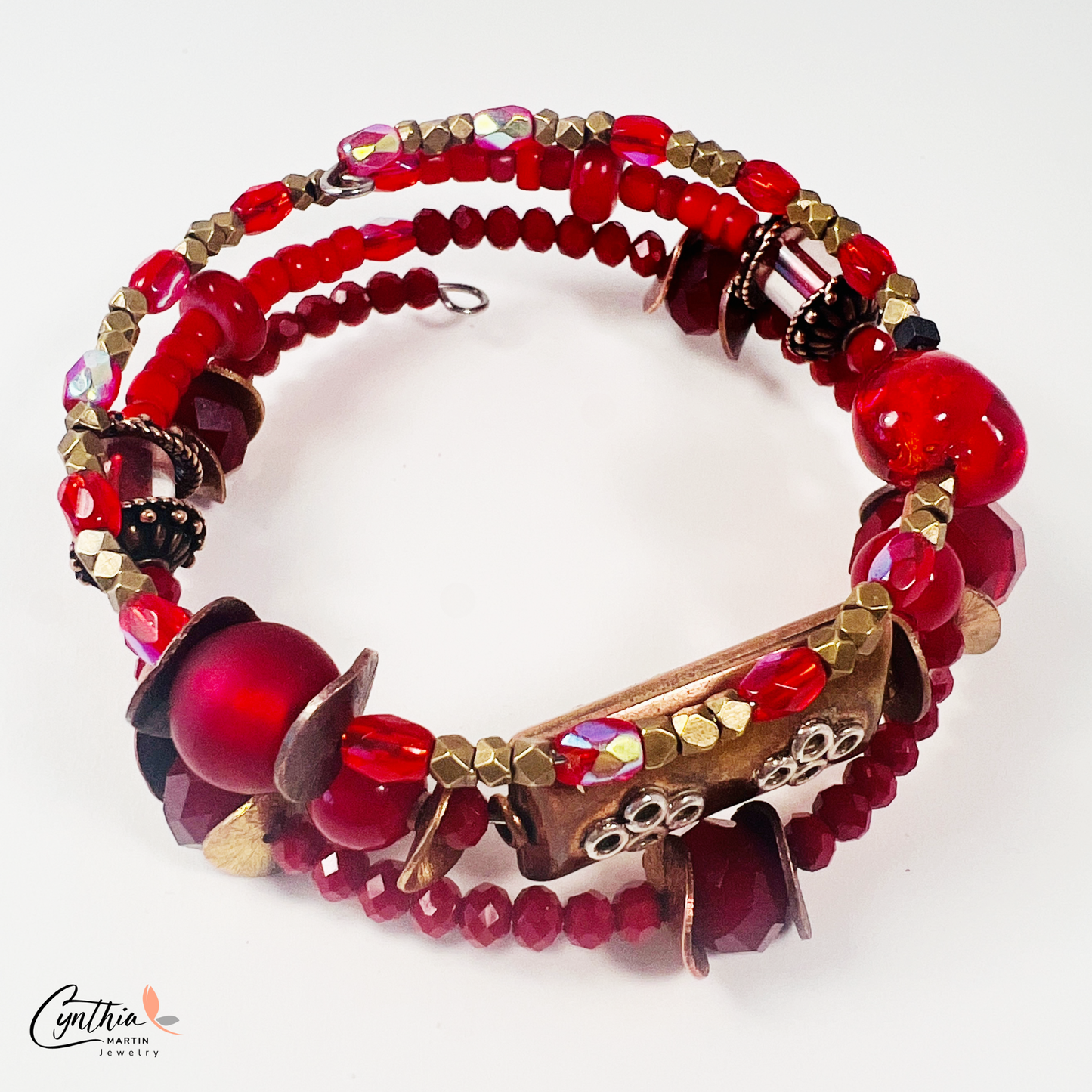 Three-layer wrap bracelet featuring deep red faceted beads and elegant copper spacers, designed for vibrant style.
