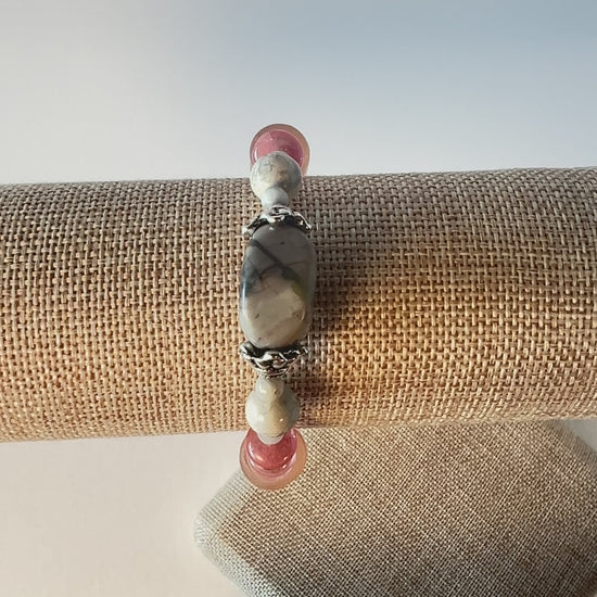 Subtle colors of grey and peach are beautiful together. Whispers soft and dainty. Silver bead caps top this sweetness off. Silver metal, wrist size 7 1/4 in.