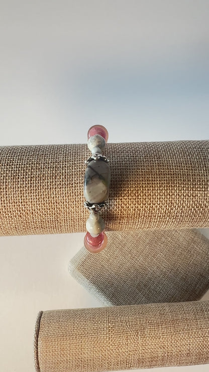 Subtle colors of grey and peach are beautiful together. Whispers soft and dainty. Silver bead caps top this sweetness off. Silver metal, wrist size 7 1/4 in.