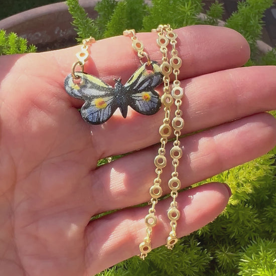 Gold small link chain with hand-painted enamel monarch butterfly pendant, blending luxury with the intricate beauty of nature.