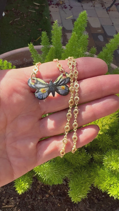 Gold small link chain with hand-painted enamel monarch butterfly pendant, blending luxury with the intricate beauty of nature.