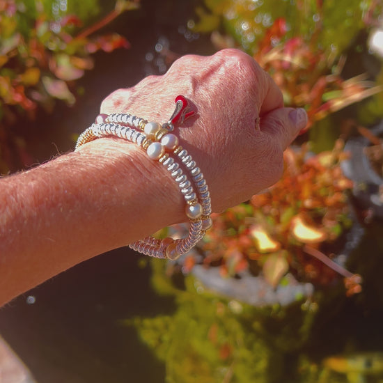 Timeless Elegance: Feminine Bangle with Lustrous Pearls, Gold, and Silver Wrapping Around Wrist in Refined Beauty