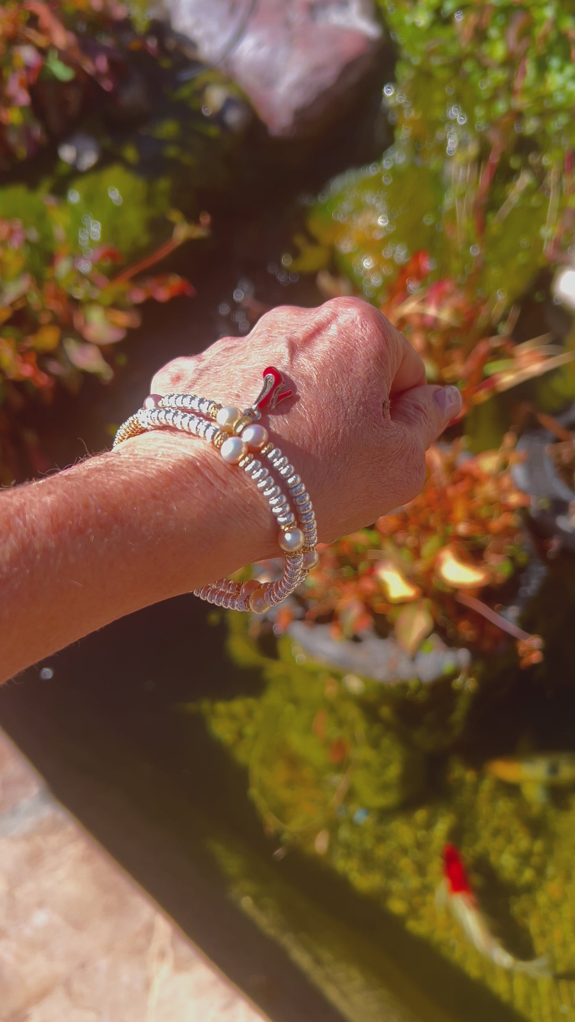 Timeless Elegance: Feminine Bangle with Lustrous Pearls, Gold, and Silver Wrapping Around Wrist in Refined Beauty