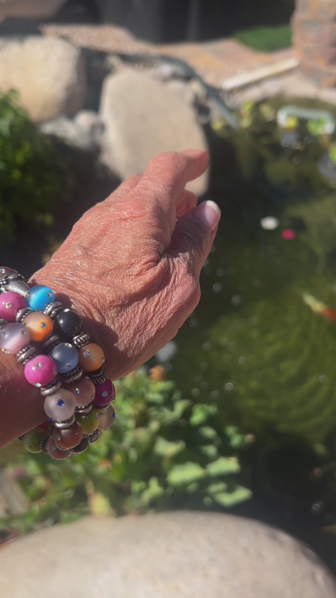 Vibrant 4-layer bracelet featuring festive colors and crystal-covered beads, accented with Bali silver spacers and caps.
