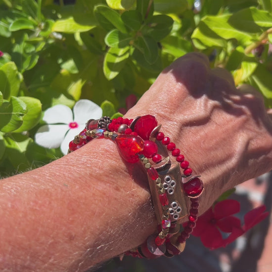 Three-layer wrap bracelet featuring deep red faceted beads and elegant copper spacers, designed for vibrant style.
