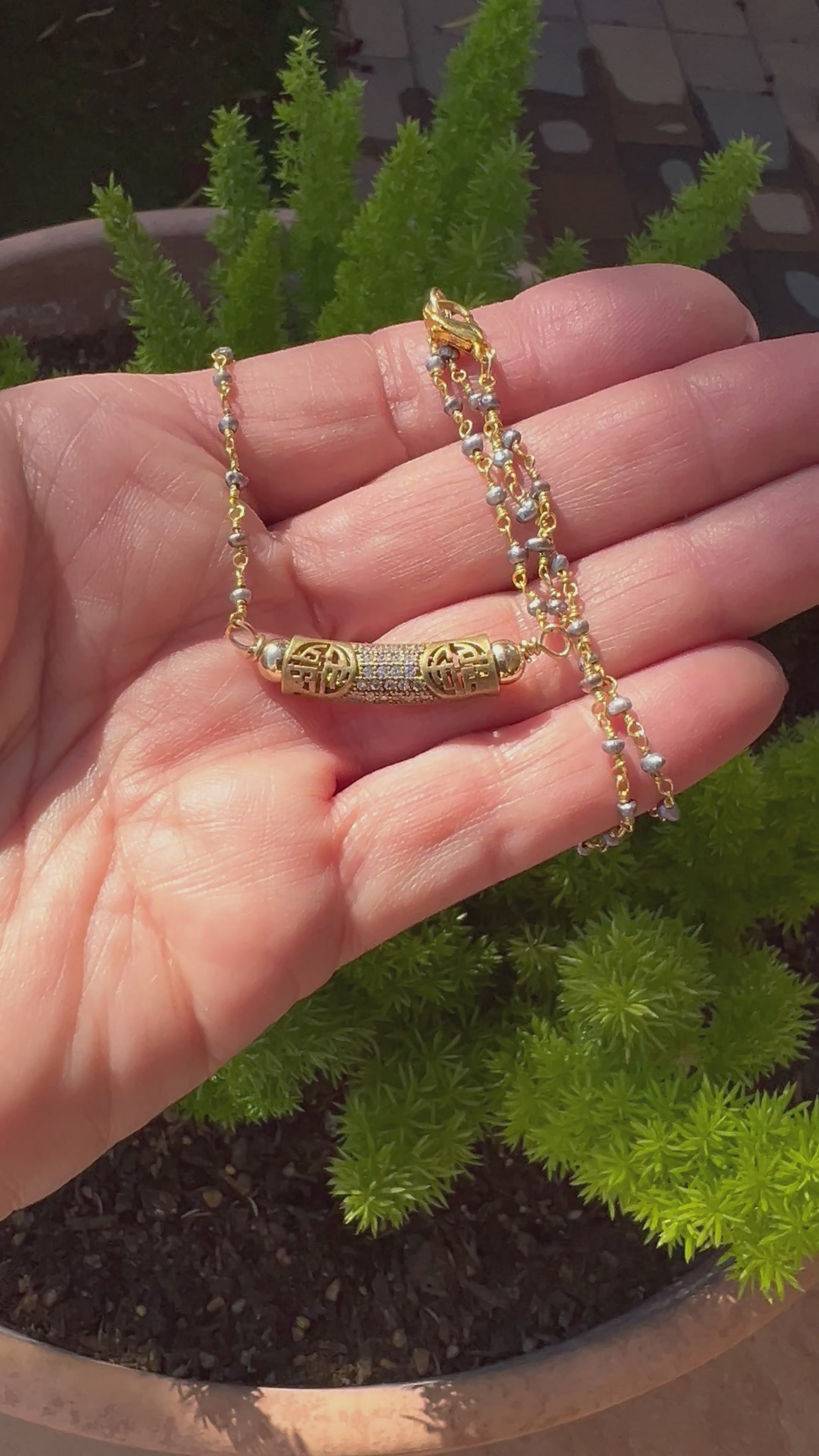 Tiny gold beaded chain with antiqued brass pave tube pendant, blending vintage charm with elegant simplicity.